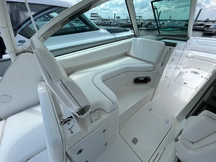  Yacht Photos Pics 2015 Pursuit DC 325 Dual Console boat interior with white seating and marina view.