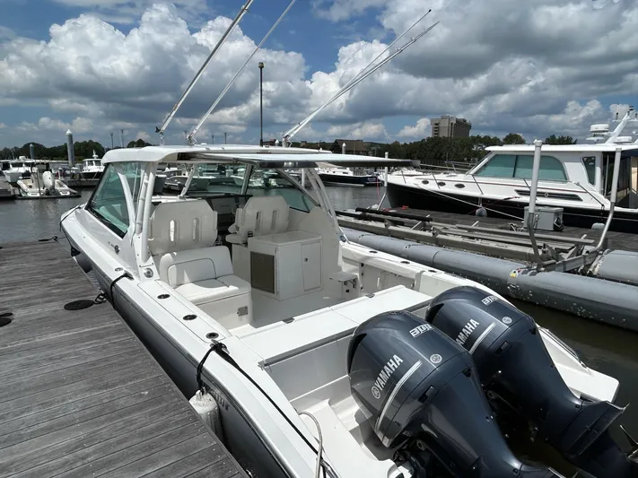  Yacht Photos Pics 2015 Pursuit DC 325 Dual Console boat docked with twin Yamaha engines.