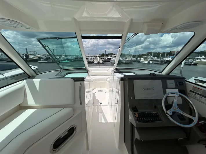  Yacht Photos Pics 2015 Pursuit DC 325 Dual Console boat interior with Garmin navigation, docked at marina.