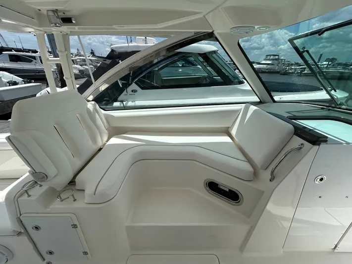  Yacht Photos Pics 2015 Pursuit DC 325 Dual Console interior with white seating and marina view.