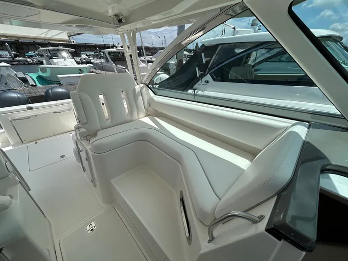  Yacht Photos Pics 2015 Pursuit DC 325 Dual Console boat interior with white seating and marina view.