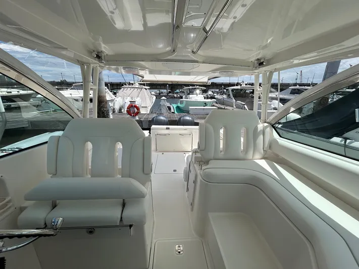  Yacht Photos Pics 2015 Pursuit DC 325 Dual Console boat interior with white seating and marina view.