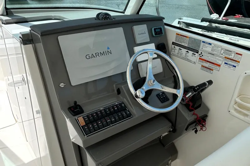  Yacht Photos Pics 2015 Pursuit DC 325 Dual Console helm with Garmin navigation system and steering wheel.