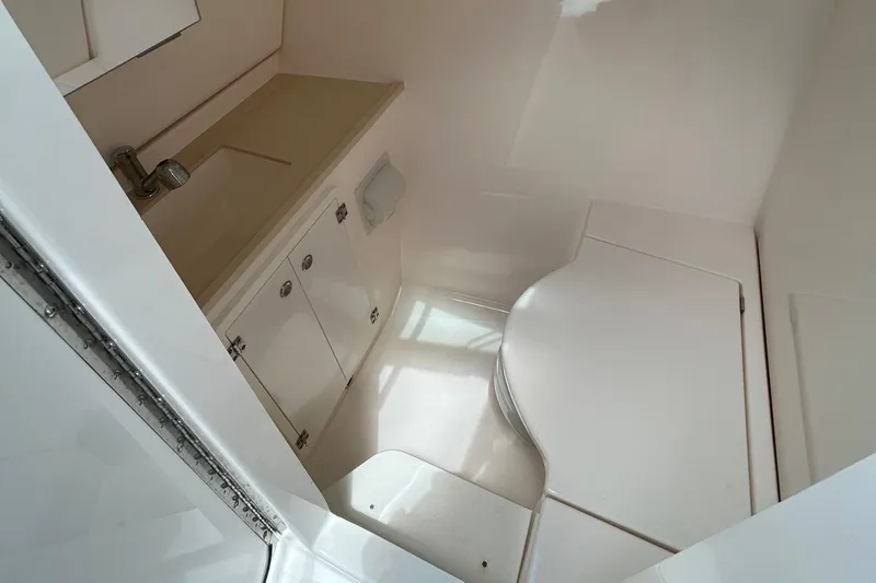  Yacht Photos Pics 2015 Pursuit DC 325 Dual Console boat interior with sink and storage cabinets.