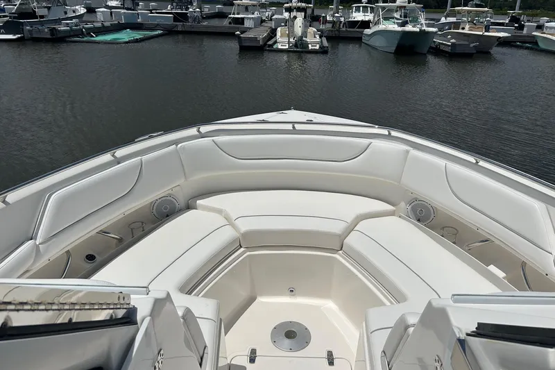  Yacht Photos Pics 2015 Pursuit DC 325 Dual Console boat interior with white seating at marina.
