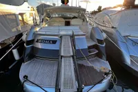 2007 Pershing 50 yacht docked, rear view with boarding ramp, surrounded by other boats.
