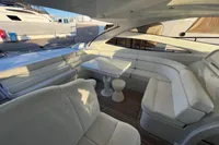 Luxurious seating area on a 2007 Pershing 50 yacht with white leather upholstery.