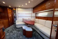 Luxurious interior of a 2007 Pershing 50 yacht with elegant seating and wooden accents.