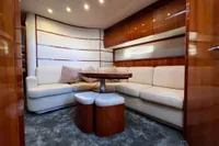Luxurious interior of a 2007 Pershing 50 yacht with plush seating and elegant wood finishes.