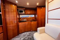 Luxurious interior of a 2007 Pershing 50 yacht with wood paneling and modern amenities.