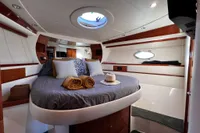 Luxurious 2007 Pershing 50 yacht bedroom with elegant bedding and modern design.