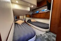 Luxurious 2007 Pershing 50 yacht cabin with twin beds and modern wood paneling.