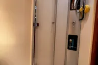 Shower area in 2007 Pershing 50 yacht with modern fixtures and storage shelves.