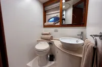 Luxurious bathroom in a 2007 Pershing 50 yacht, featuring modern fixtures and elegant design.