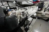 Engine room of a 2007 Pershing 50 yacht, showcasing detailed machinery and components.