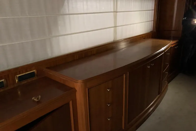  Yacht Photos Pics Luxurious wooden interior of 1998 Sanlorenzo 82 yacht, featuring elegant cabinetry.