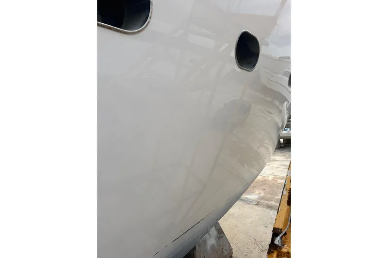  Yacht Photos Pics Close-up of 1998 Sanlorenzo 82 yacht hull with portholes.