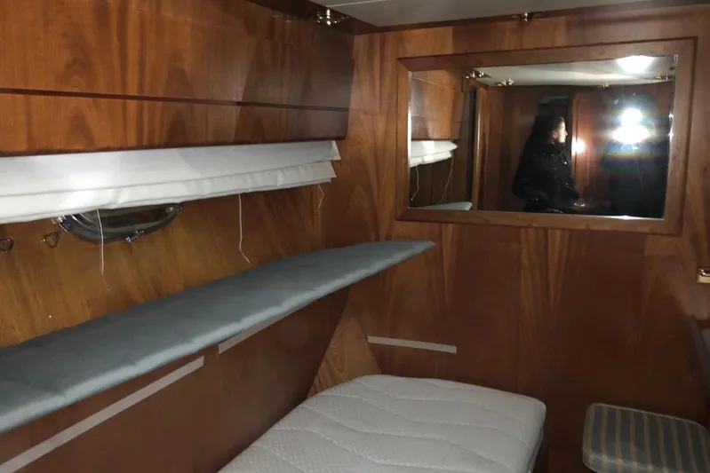  Yacht Photos Pics Interior cabin of 1998 Sanlorenzo 82 yacht with wood paneling and mirror.