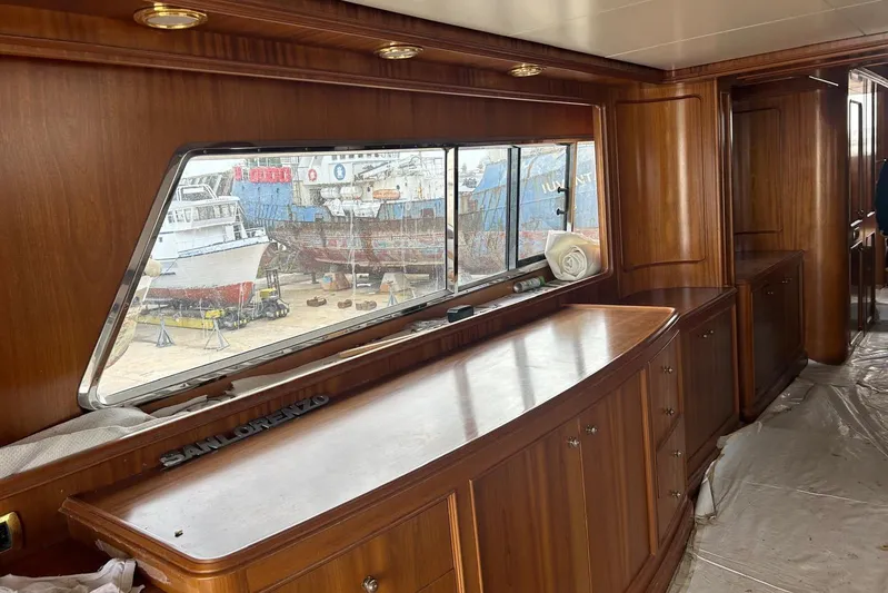  Yacht Photos Pics Interior of 1998 Sanlorenzo 82 yacht with wooden cabinetry and large window view.