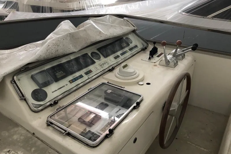  Yacht Photos Pics Control panel of a 1998 Sanlorenzo 82 yacht with steering wheel and navigation instruments.