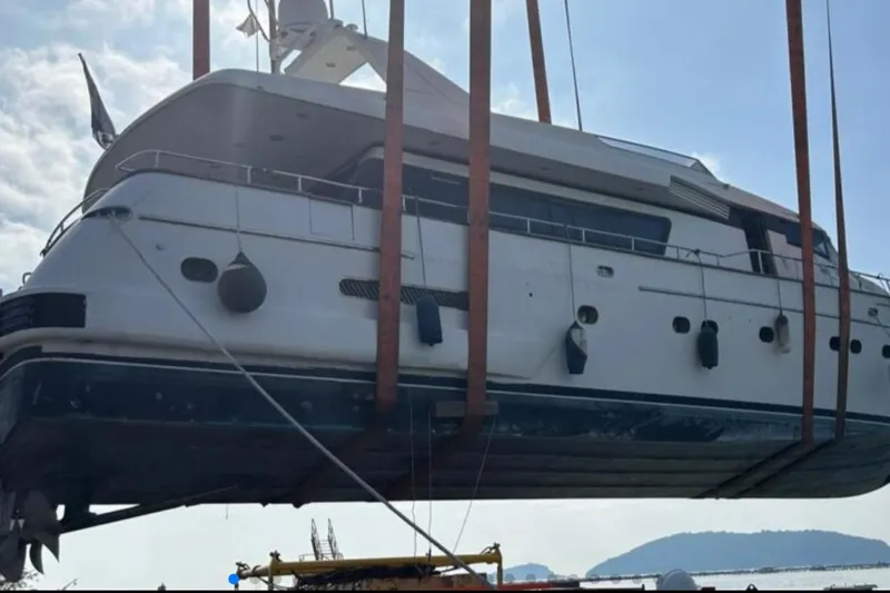  Yacht Photos Pics Sanlorenzo 82 yacht from 1998 being lifted by crane, side view.