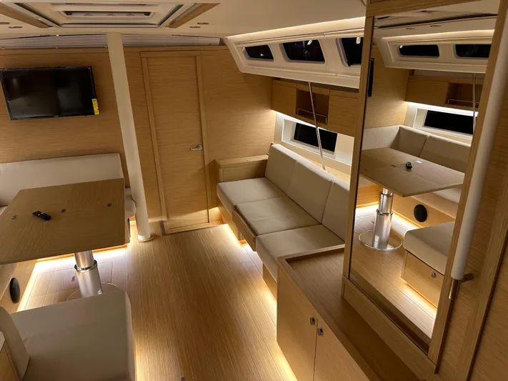 The Perch Yacht Photos Pics Luxurious interior of 2023 Grand Soleil 46 LC yacht with modern furnishings and ambient lighting.