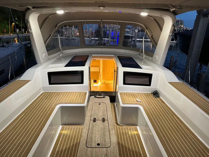 The Perch Yacht Photos Pics Grand Soleil 46 LC 2023 yacht cockpit with elegant wood finish and ambient lighting at a marina.