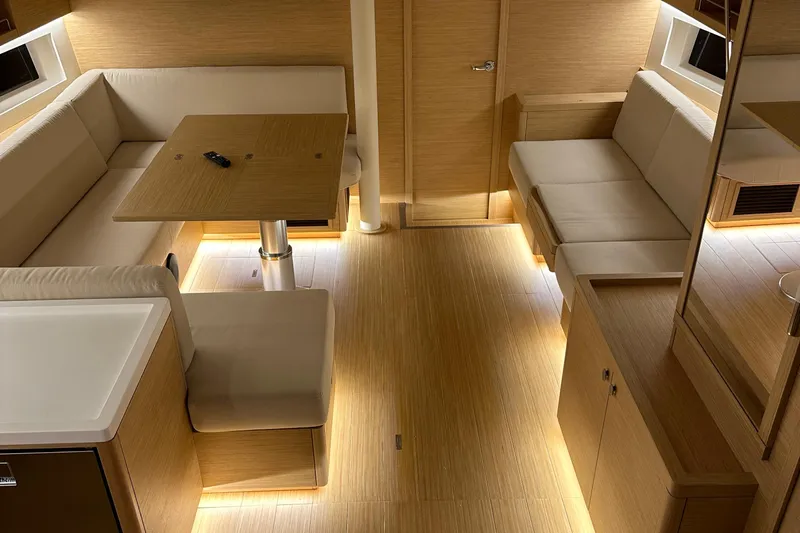 The Perch Yacht Photos Pics Luxurious interior of 2023 Grand Soleil 46 LC yacht with elegant seating and ambient lighting.