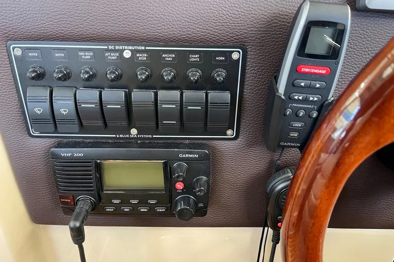  Yacht Photos Pics Control panel of a 2015 Cutwater C-28 boat with Garmin VHF 200 radio and switches.