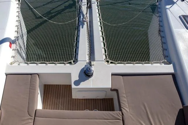 Yacht Photos Pics 2019 Lagoon 450S catamaran deck with netting and cushioned seating.