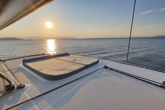  Yacht Photos Pics 2019 Lagoon 450S catamaran deck at sunset, serene ocean view.
