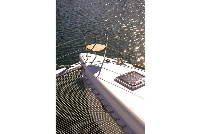  Yacht Photos Pics 2019 Lagoon 450S catamaran deck with chair, sunlit water in background.