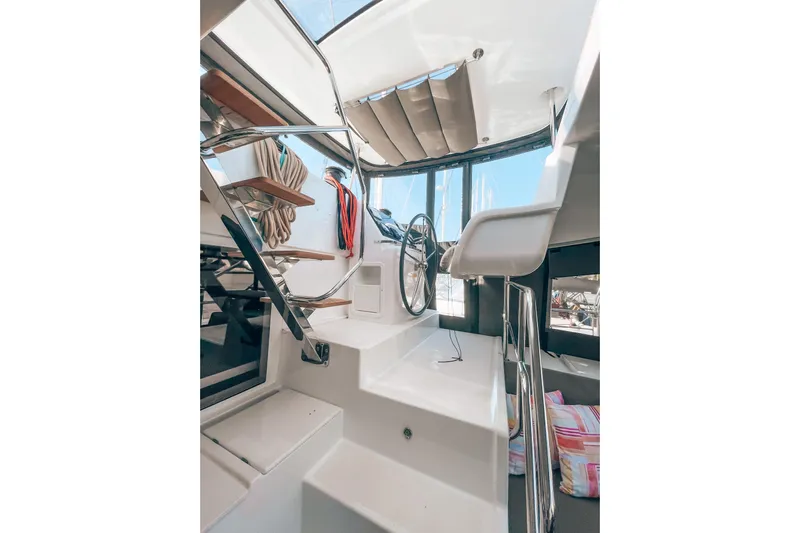  Yacht Photos Pics Interior view of 2019 Lagoon 450S yacht with steering wheel and seating area.