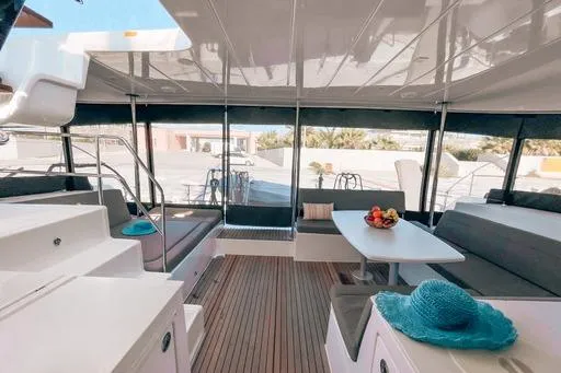  Yacht Photos Pics 2019 Lagoon 450S yacht interior with seating, table, and fruit bowl.