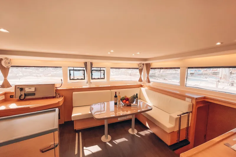  Yacht Photos Pics Luxurious interior of 2019 Lagoon 450S catamaran with elegant seating and dining area.
