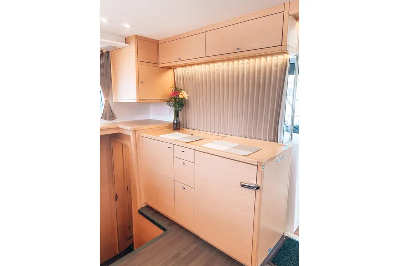  Yacht Photos Pics Interior of 2019 Lagoon 450S yacht with modern wooden cabinetry and elegant decor.