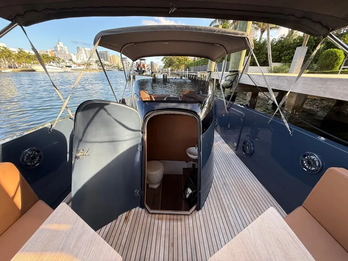  Yacht Photos Pics 2021 Frauscher 1017 GT Air boat with open deck and cabin, docked by the water.