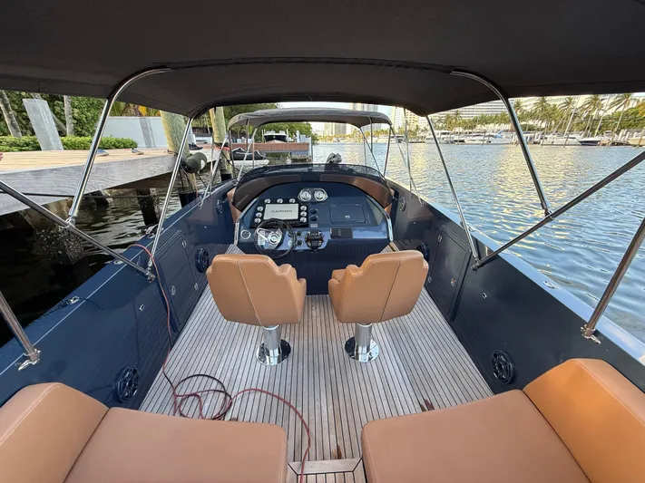  Yacht Photos Pics 2021 Frauscher 1017 GT Air boat interior with tan seats and modern dashboard.