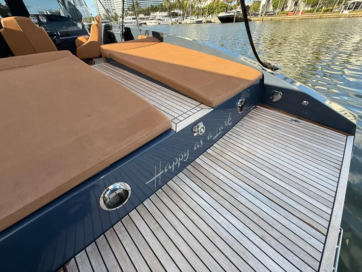  Yacht Photos Pics Frauscher 1017 GT Air 2021 yacht with teak deck and cushioned seating by the water.