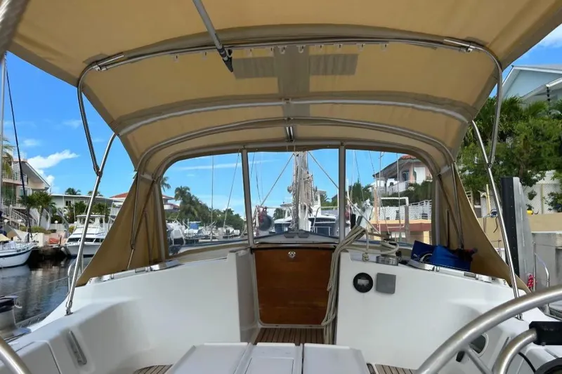 Zephyrus Yacht Photos Pics Cockpit view of 1991 Beneteau Oceanis 50 sailboat docked in a marina.