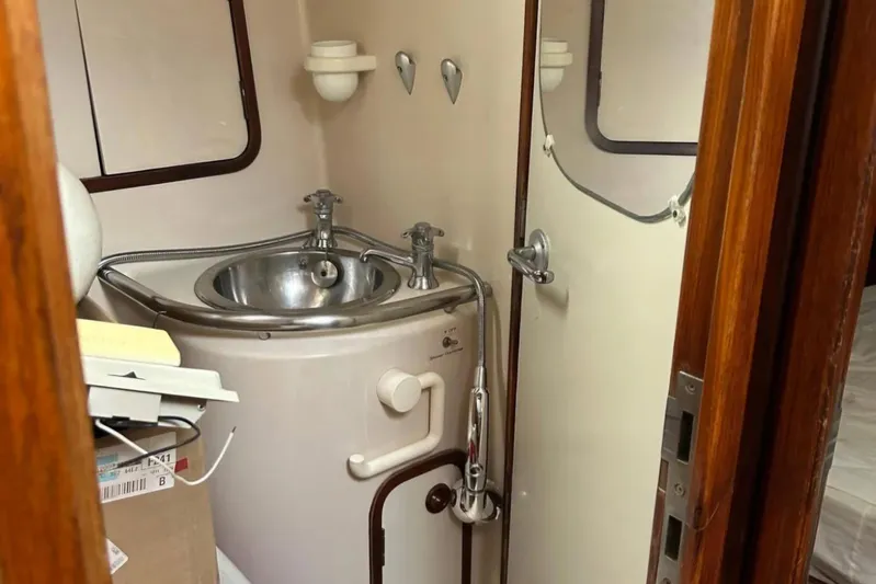Zephyrus Yacht Photos Pics Bathroom interior of 1991 Beneteau Oceanis 50 yacht with sink and shower.