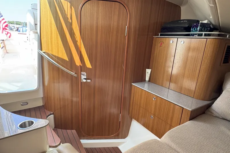  Yacht Photos Pics Interior of 2006 Pursuit LS 345 Drummond Runner with wooden cabinetry and seating.
