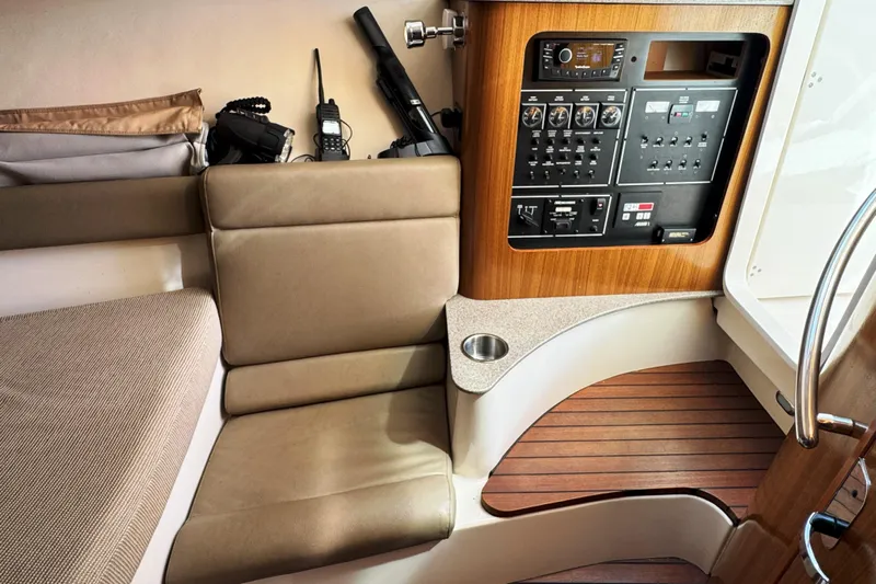  Yacht Photos Pics Interior of 2006 Pursuit LS 345 Drummond Runner with control panel and seating area.