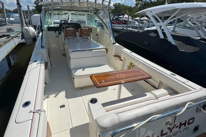  Yacht Photos Pics 2006 Pursuit LS 345 Drummond Runner boat interior with seating and wooden table.