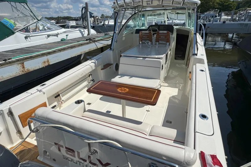  Yacht Photos Pics 2006 Pursuit LS 345 Drummond Runner boat docked, featuring spacious seating and a wooden table.