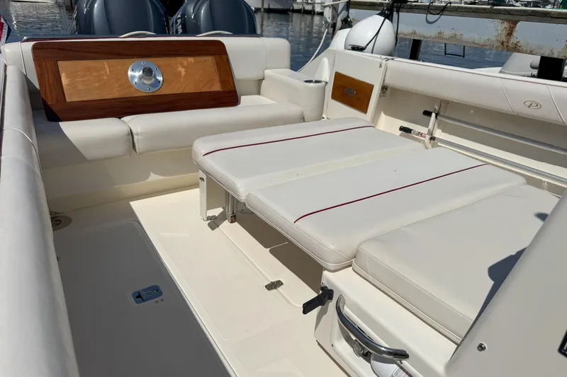  Yacht Photos Pics 2006 Pursuit LS 345 Drummond Runner boat interior with cushioned seating and wooden accents.