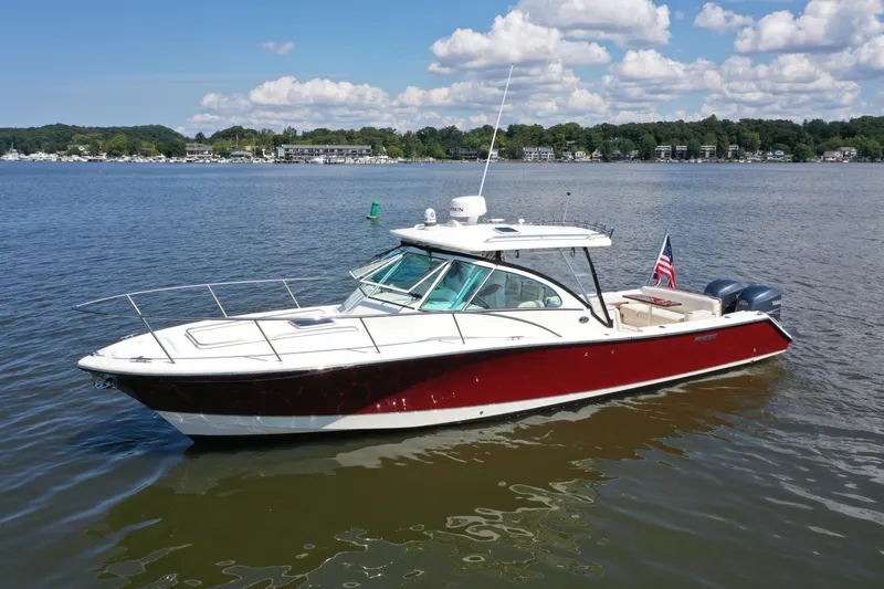 Yacht Photos Pics 2006 Pursuit LS 345 Drummond Runner boat on calm water, American flag displayed.