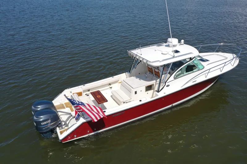  Yacht Photos Pics 2006 Pursuit LS 345 Drummond Runner boat on water with American flag.