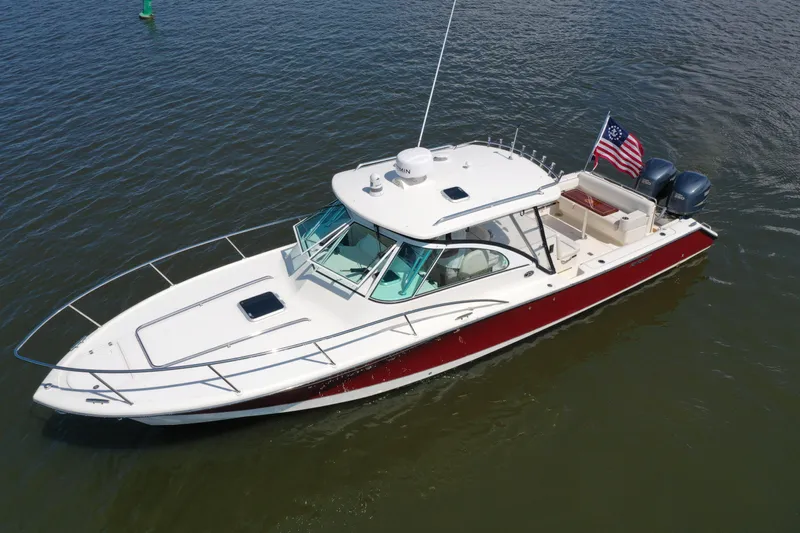  Yacht Photos Pics 2006 Pursuit LS 345 Drummond Runner boat on water, American flag, dual engines.