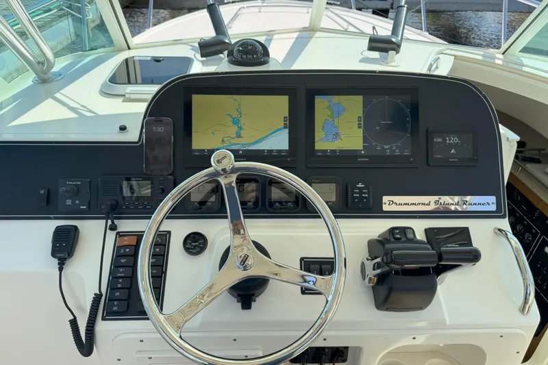  Yacht Photos Pics 2006 Pursuit LS 345 Drummond Runner helm with navigation screens and controls.